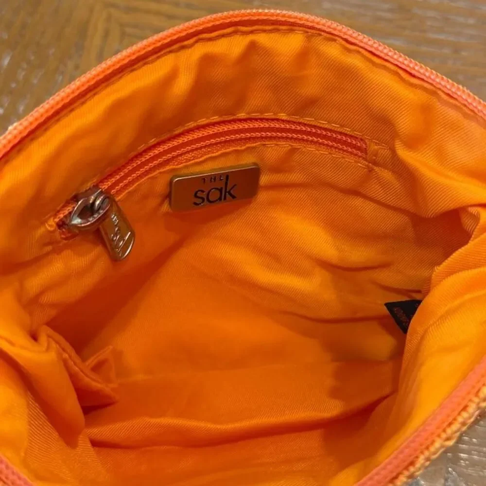 The Sak Crochet Orange Cosmetic Pouch Bag